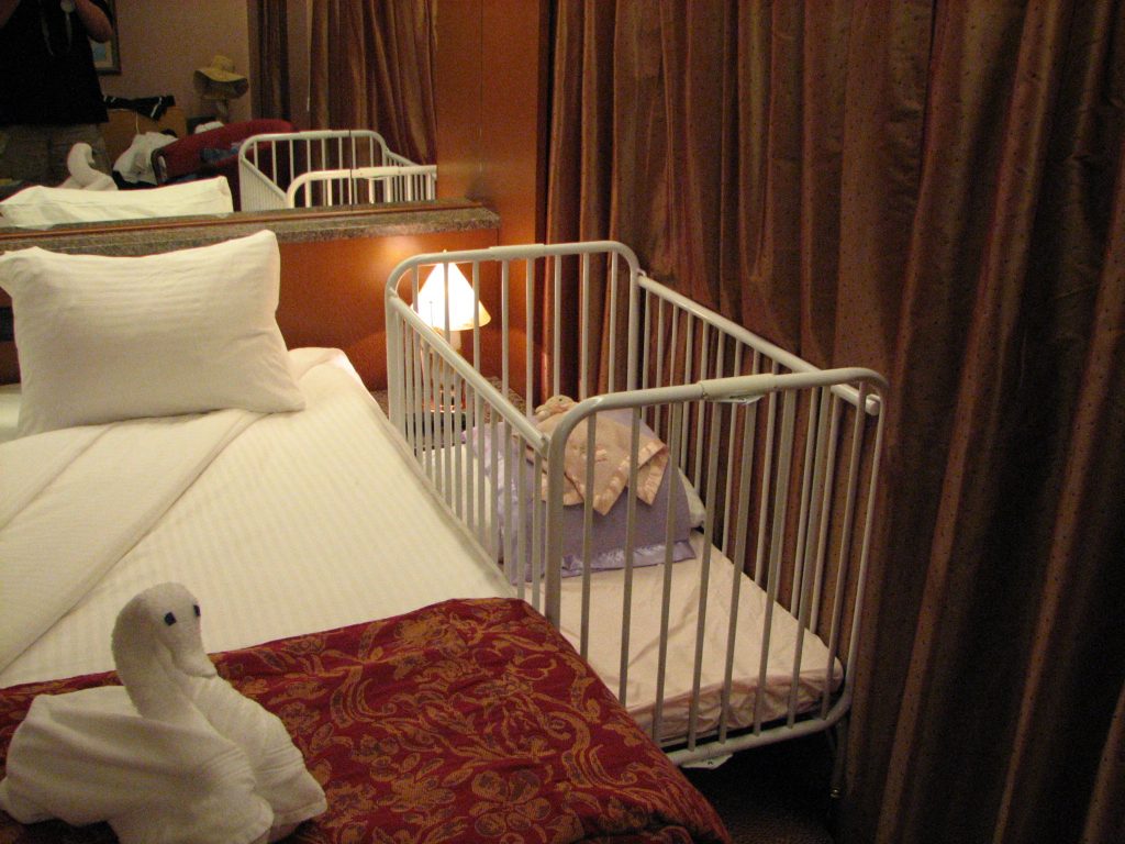 Cruise ship cabin with crib.