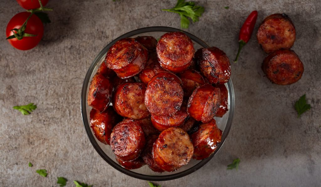 Slices of fried pork sausages in a bowl