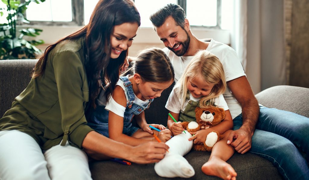 family resting at home kids writing something using colored pen