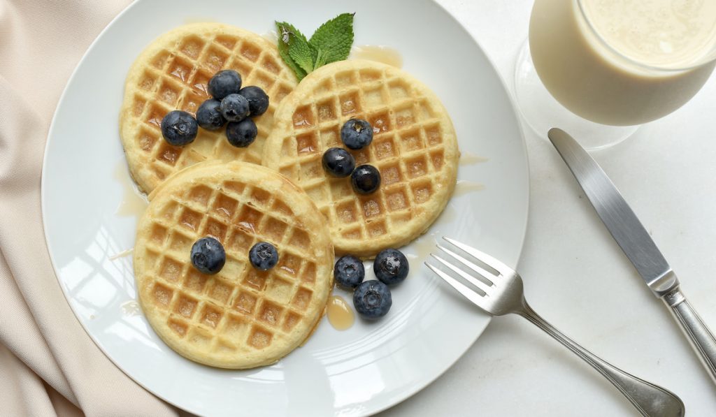 waffles with blueberry and honey on a plate